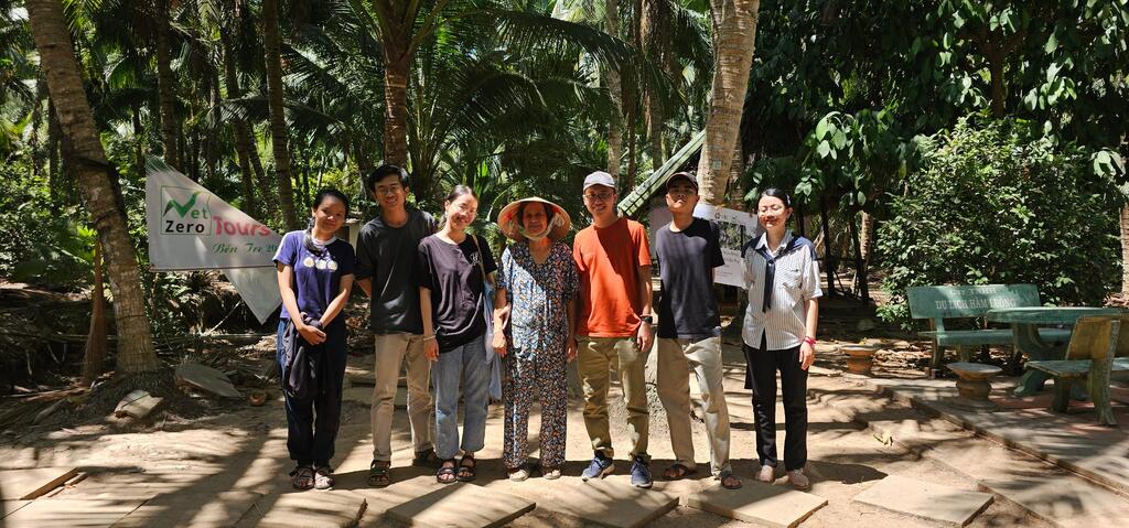 A group with their host in a coconut garden in Bến Tre.