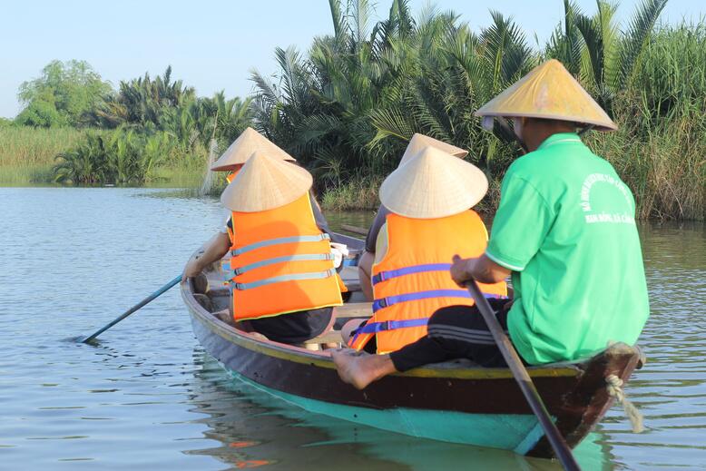 Rowing between nipa palms on the river near Hội An.